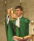 A person in green robe
        holding a gold cupDescription automatically generated